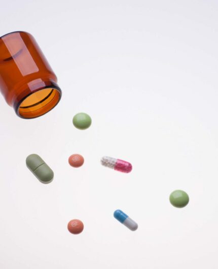 various medicine drugs with pill jar on lab light table, photo