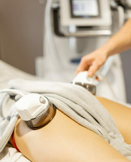 Applying vacuum roller massage to female leg using a special nozzle at beauty medical center, close-up. Concept of modern medical procedures for beauty